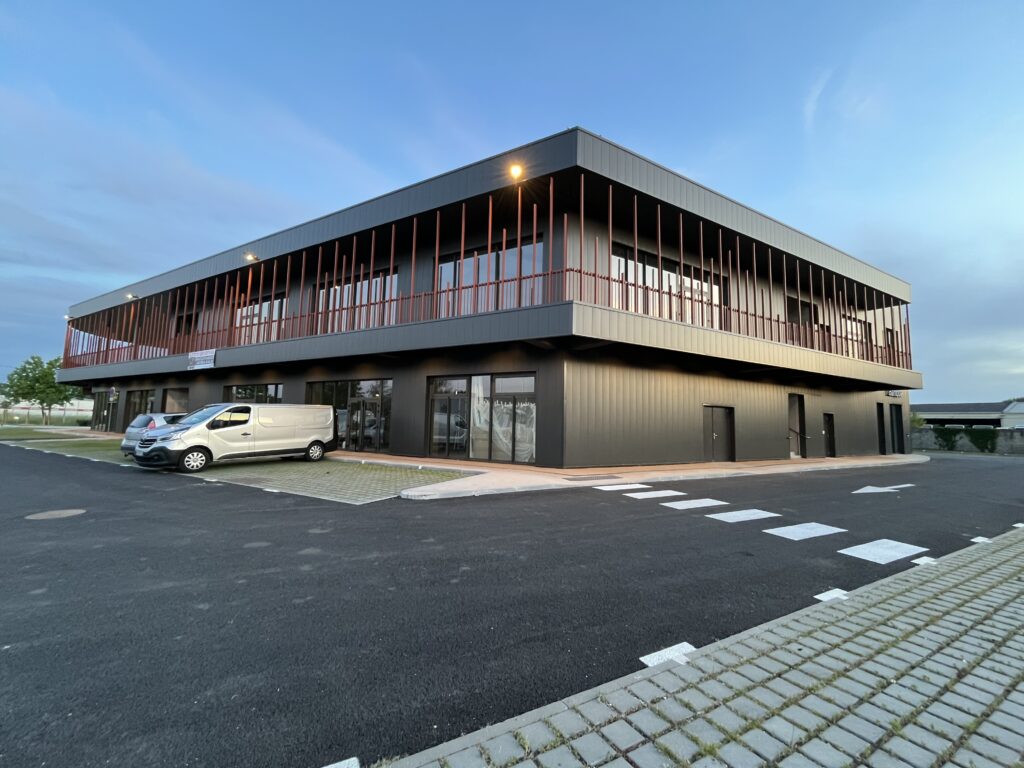 Façade moderne de la boulangerie martillac avec grande vitrine et parking devant.
